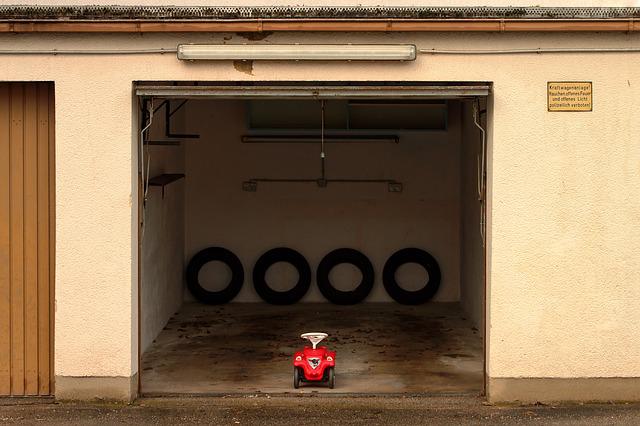 old garage door open with tires and small toy