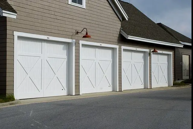 4 white garage doors on house