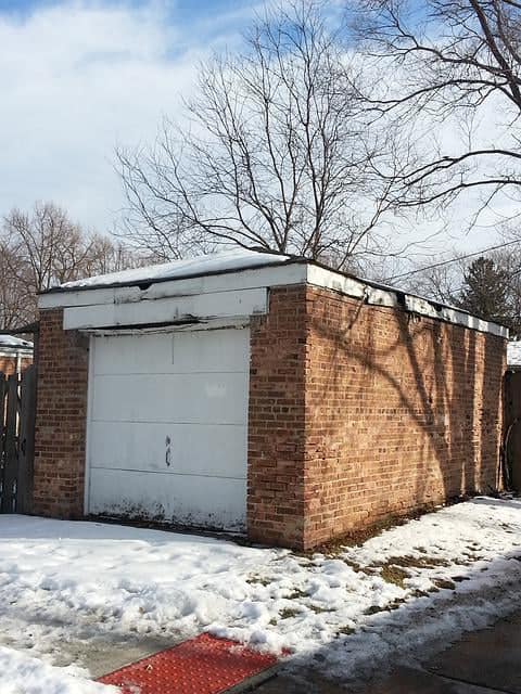 single white panel based garage door detached brick
