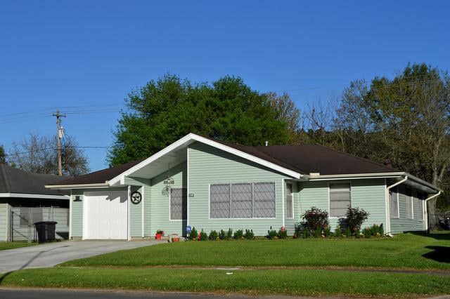 small white garage door panel based on green house