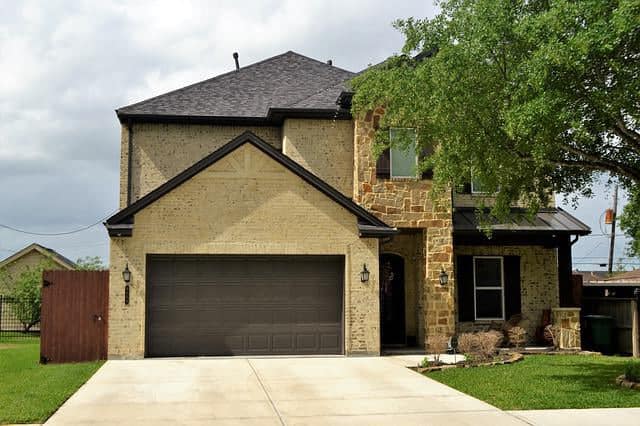 double garage door in green on olive house