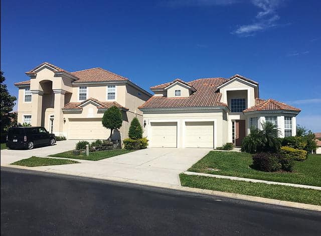 double garage door next to two single garage doors panel based cream