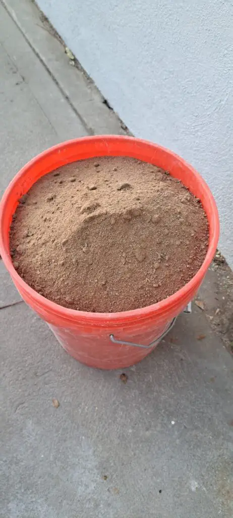 For loose sandy or gravelly soils remove at least 5 gallons of soil. For clay or tight-packed soils remove at least 15 gallons.